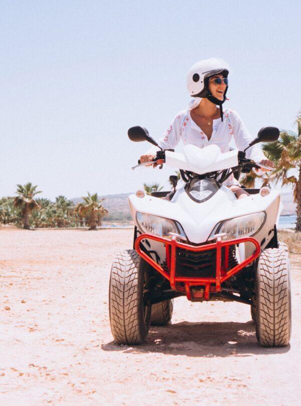 Woman travelling on quad by th ocean